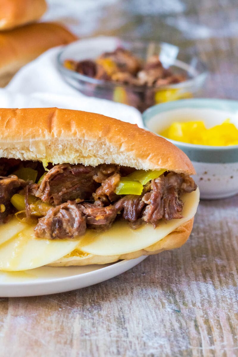Italian beef sandwich on a plate with cheese.