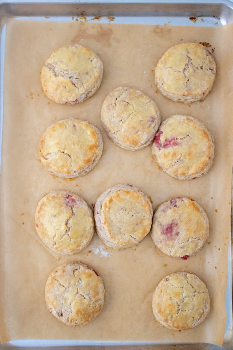 Strawberry biscuits on a baking sheet after baking.