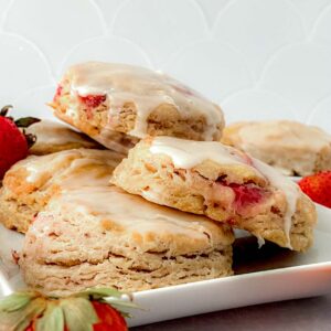 Side view of copycat Popeyes strawberry biscuits on a plate.