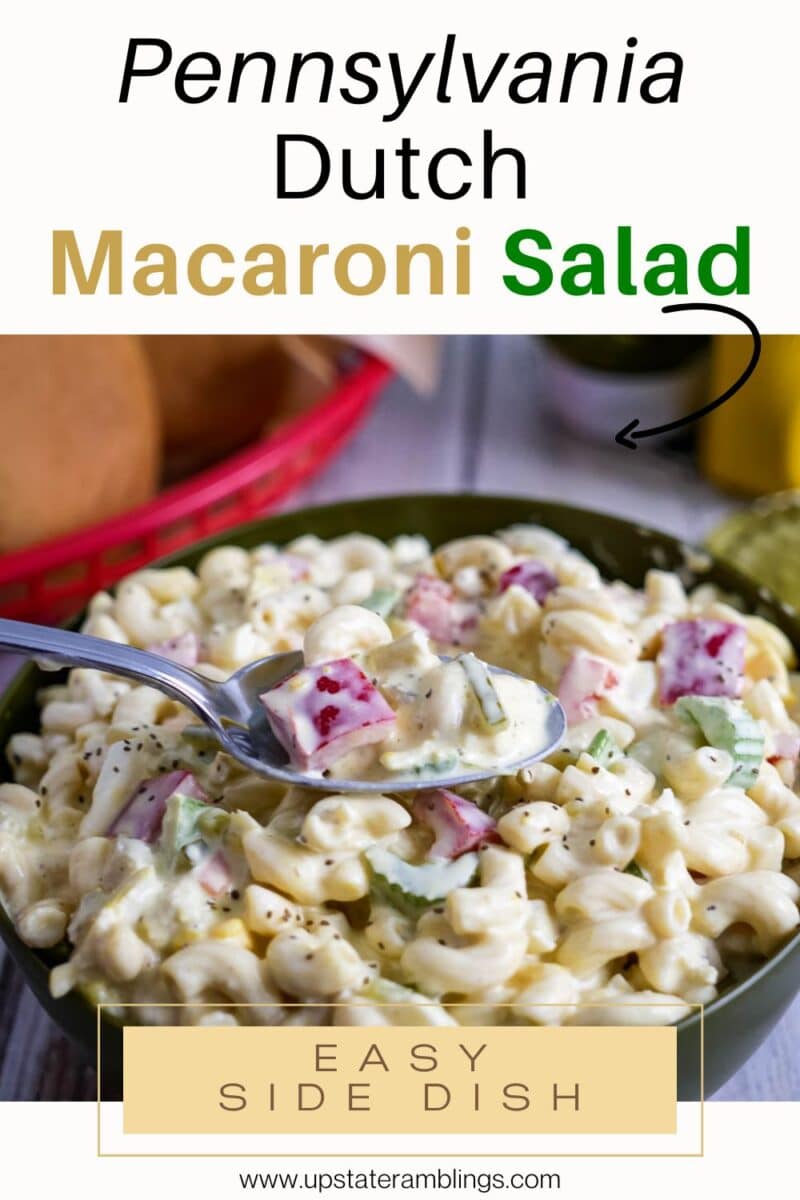 A bowl of Amish macaroni salad with diced vegetables and creamy dressing, with a spoonful being lifted from the bowl. Text overlay describes the dish.