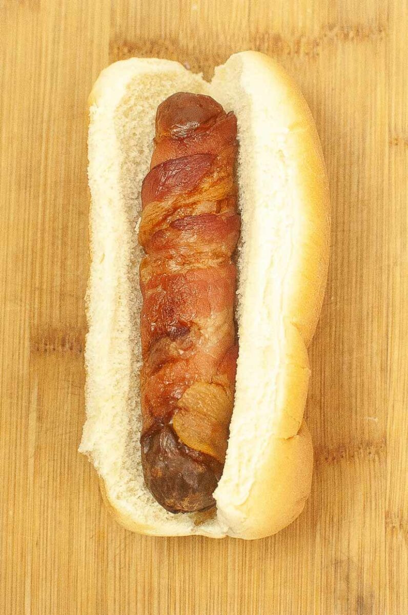 Bacon wrapped hot dog in a bun.