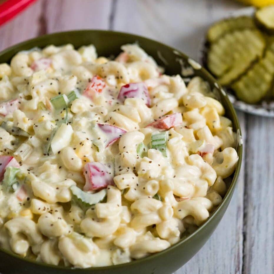 Bowl of Amish macaroni salad with some on a spoon.