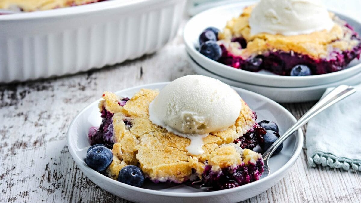 Blueberry cobbler topped with a scoop of vanilla ice cream