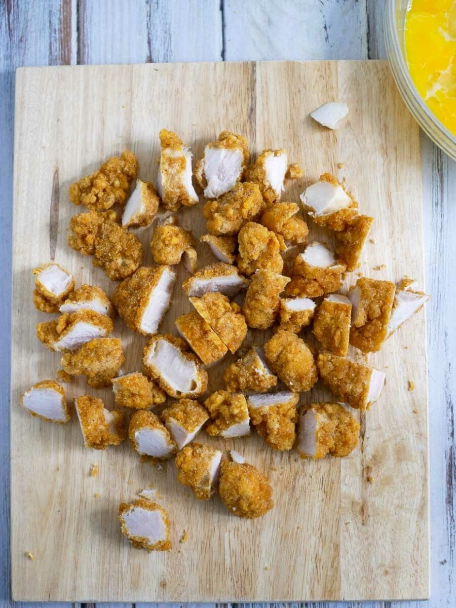 Diced chicken tenders on a cutting board.