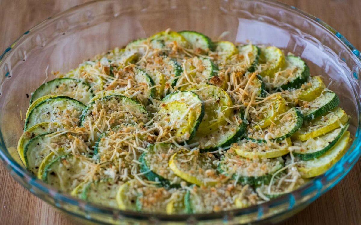 Zucchini and summer squash casserole in a pie plate with squash arrange in concentric circles.