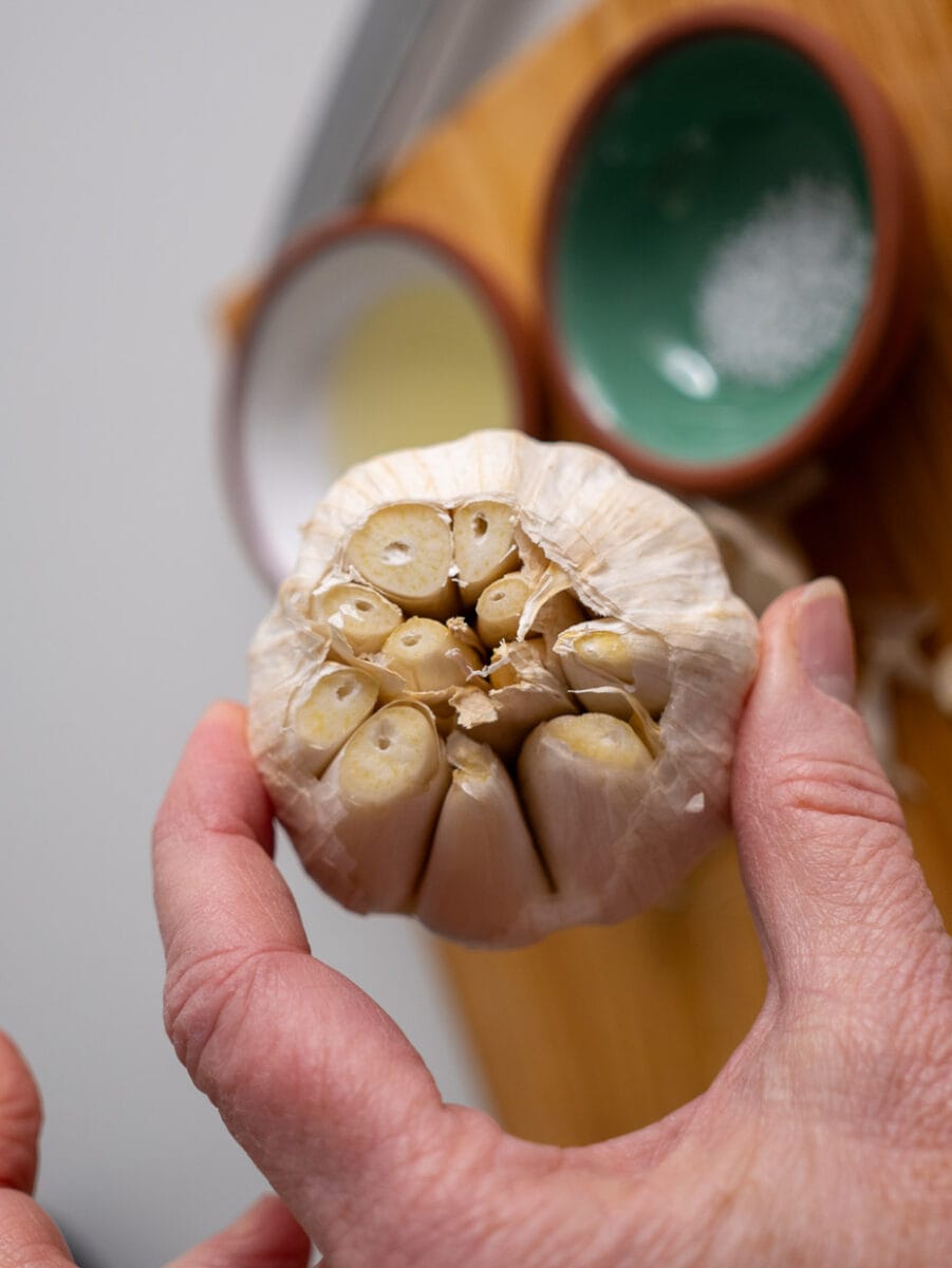 Head of garlic with the top sliced off.