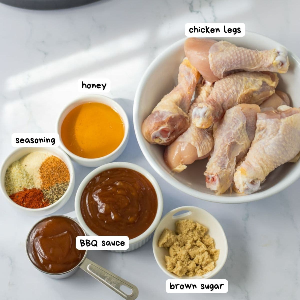 Ingredients for slow cooker bbq chicken legs with labels.