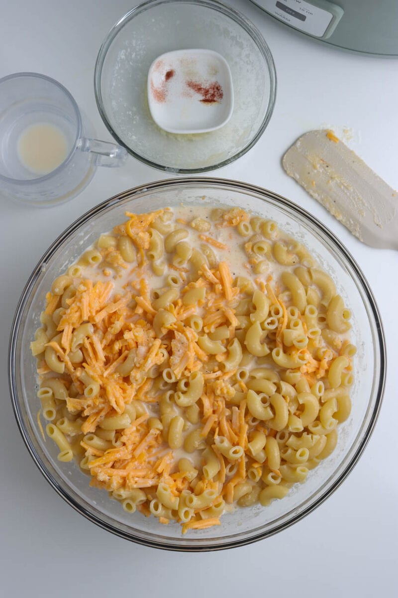 Mixing the cheese and macaroni.