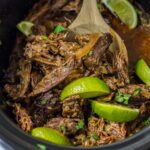 Copycat Chipotle barbacoa in the crock pot with limes.