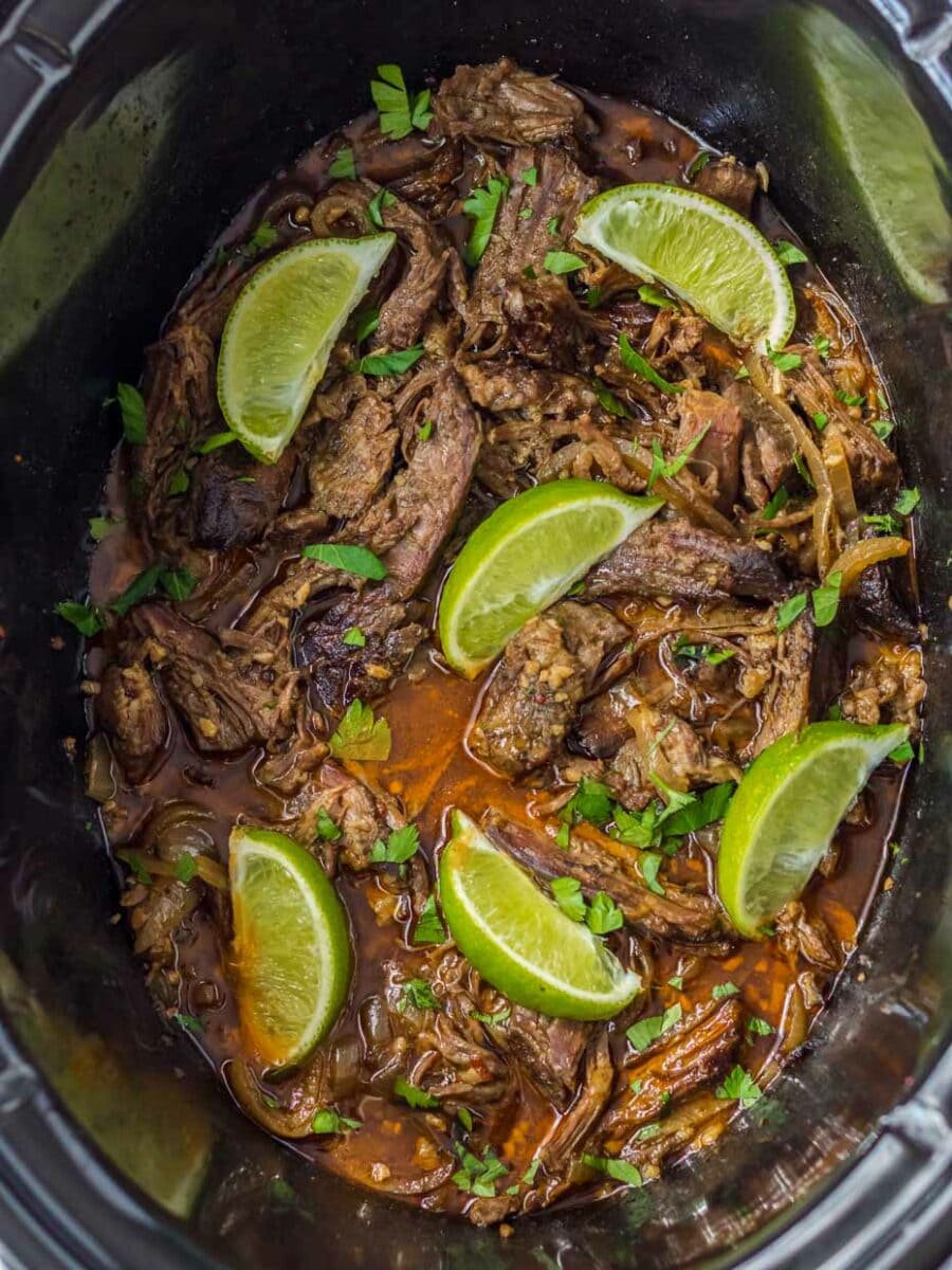 Top view of crock pot with slow cooker barbacoa.