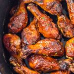 Slow cooker chicken legs with BBQ sauce in the crock pot.