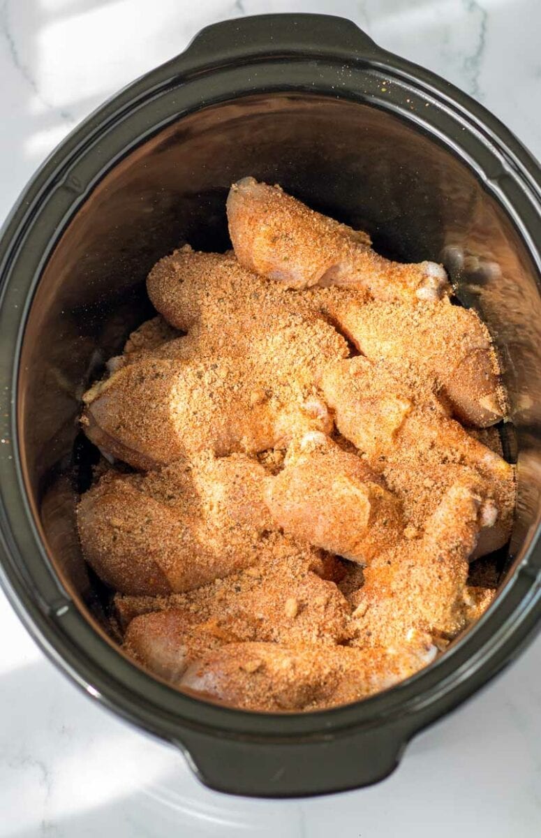 Chicken legs in crock pot before cooking.