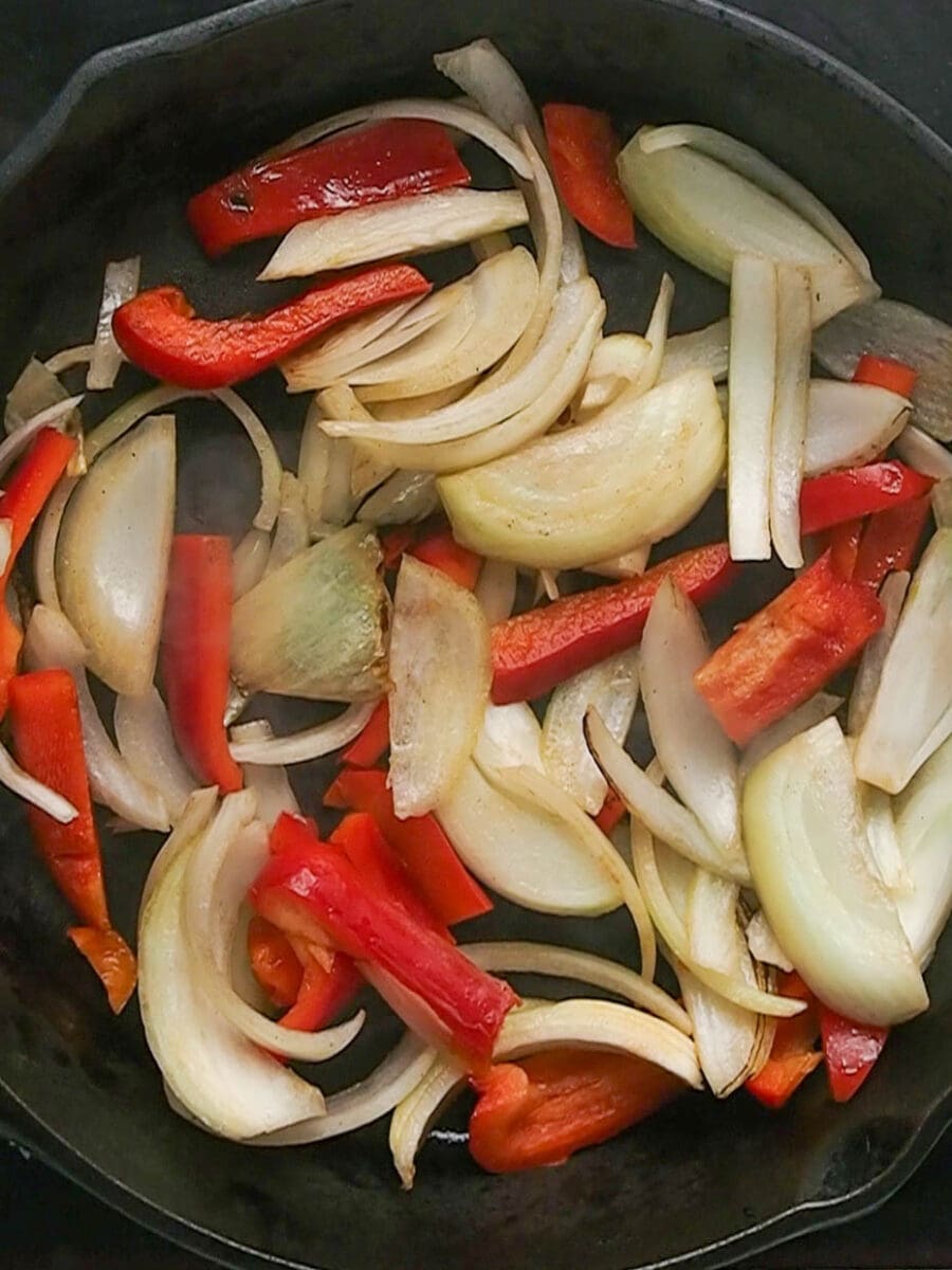 Cook peppers and onions to go with flank steak.