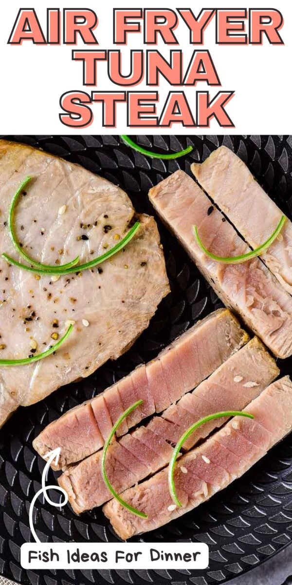 A cooked air fryer tuna steak, partially sliced, is garnished with thin lime slices and black pepper, served on a textured black plate. Text reads "Air Fryer Tuna Steak" and "Fish Ideas For Dinner.