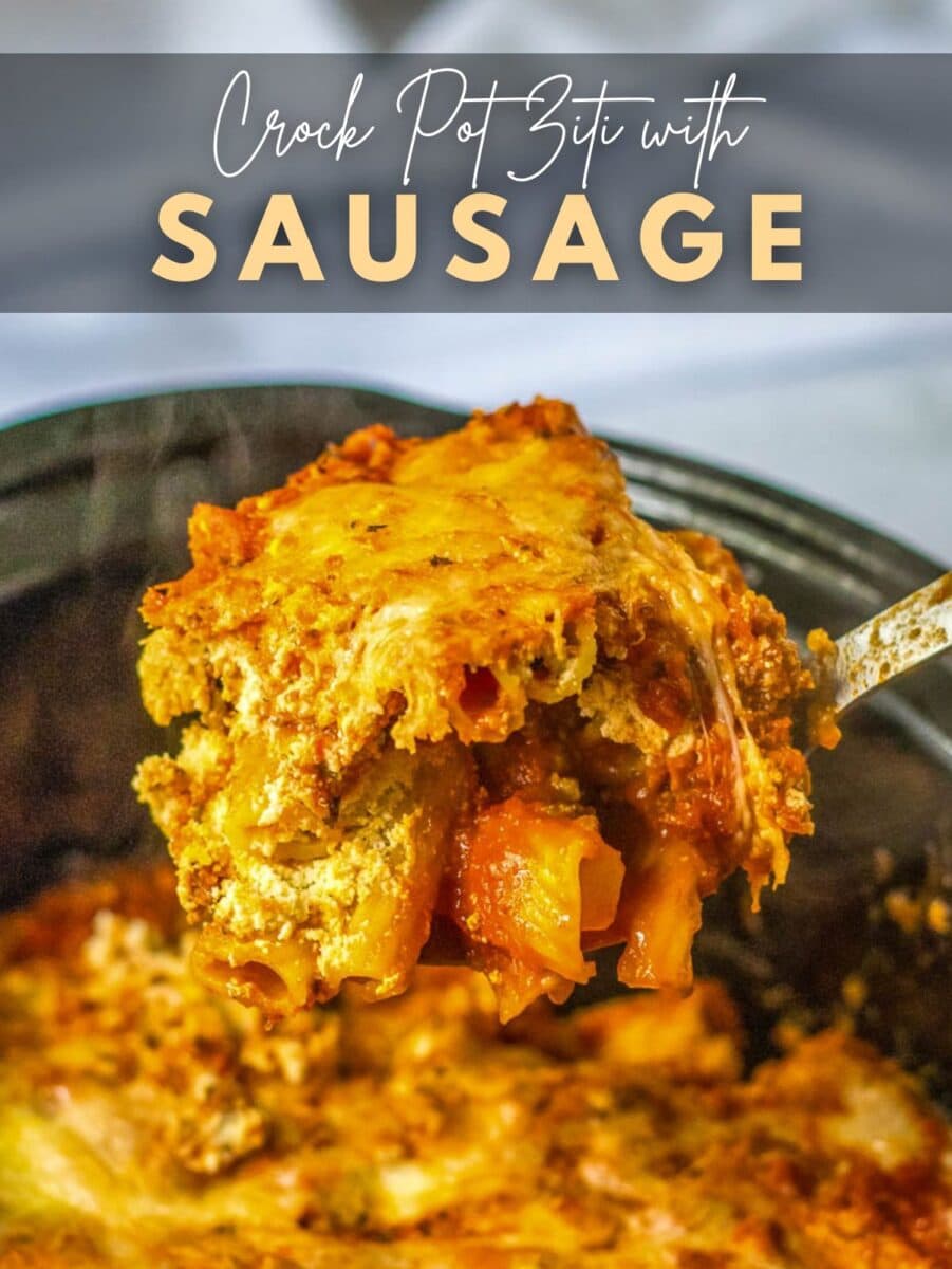 A serving of crock pot baked ziti with sausage, covered in melted cheese, being lifted from a crock pot. Text above reads "Crock Pot Ziti with Sausage.