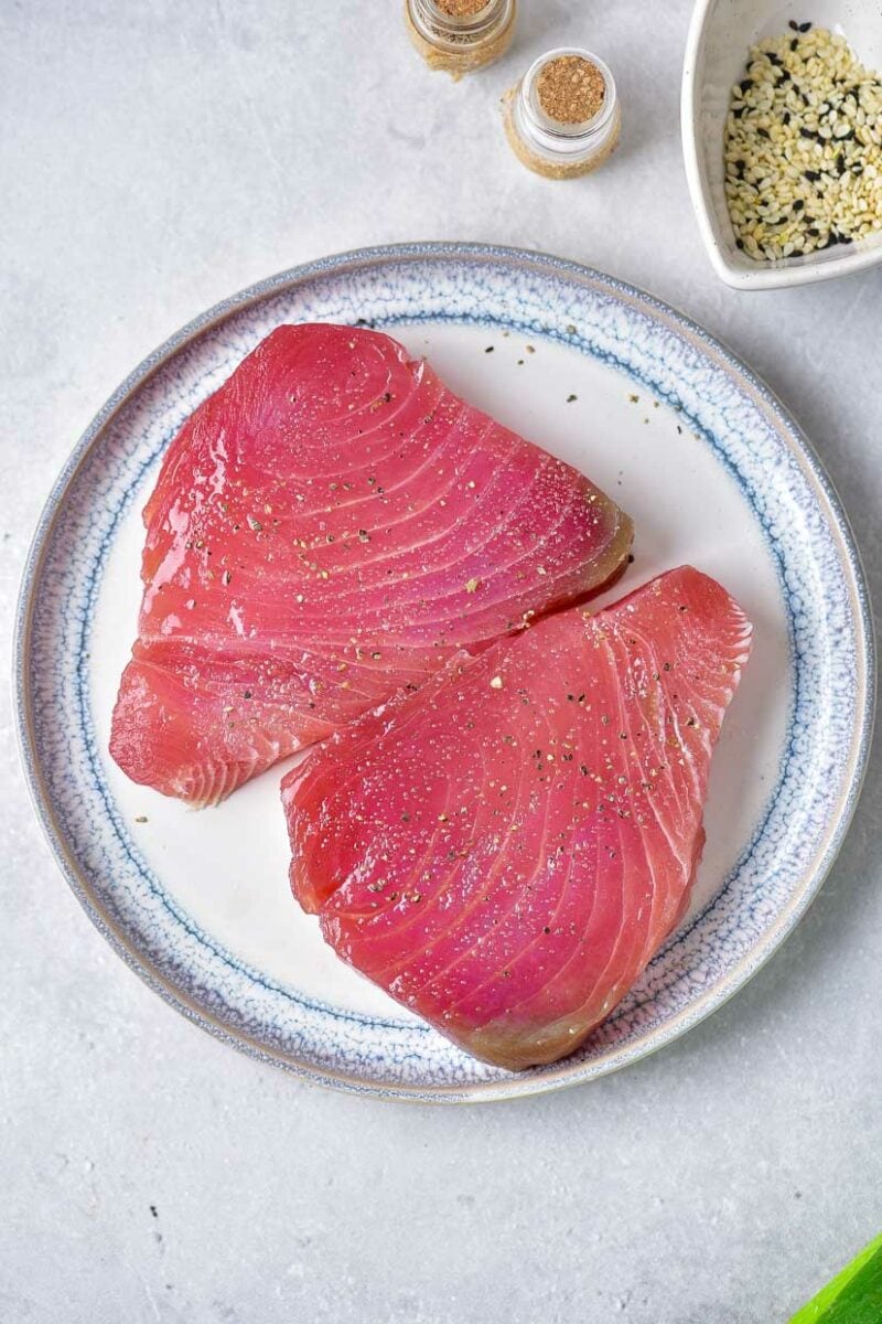 Seasoning the tuna.