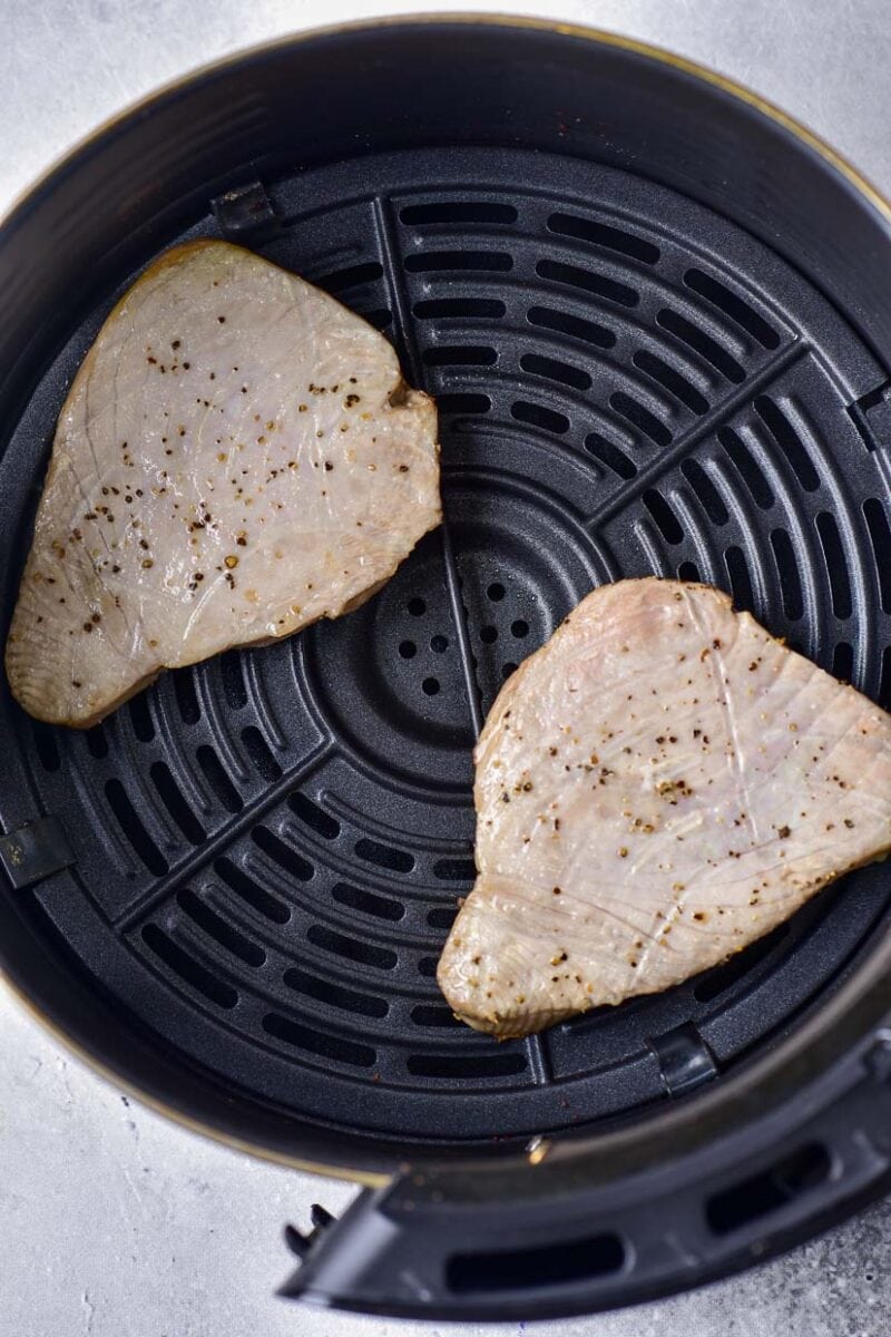 Tuna steak in air fryer after cooking.