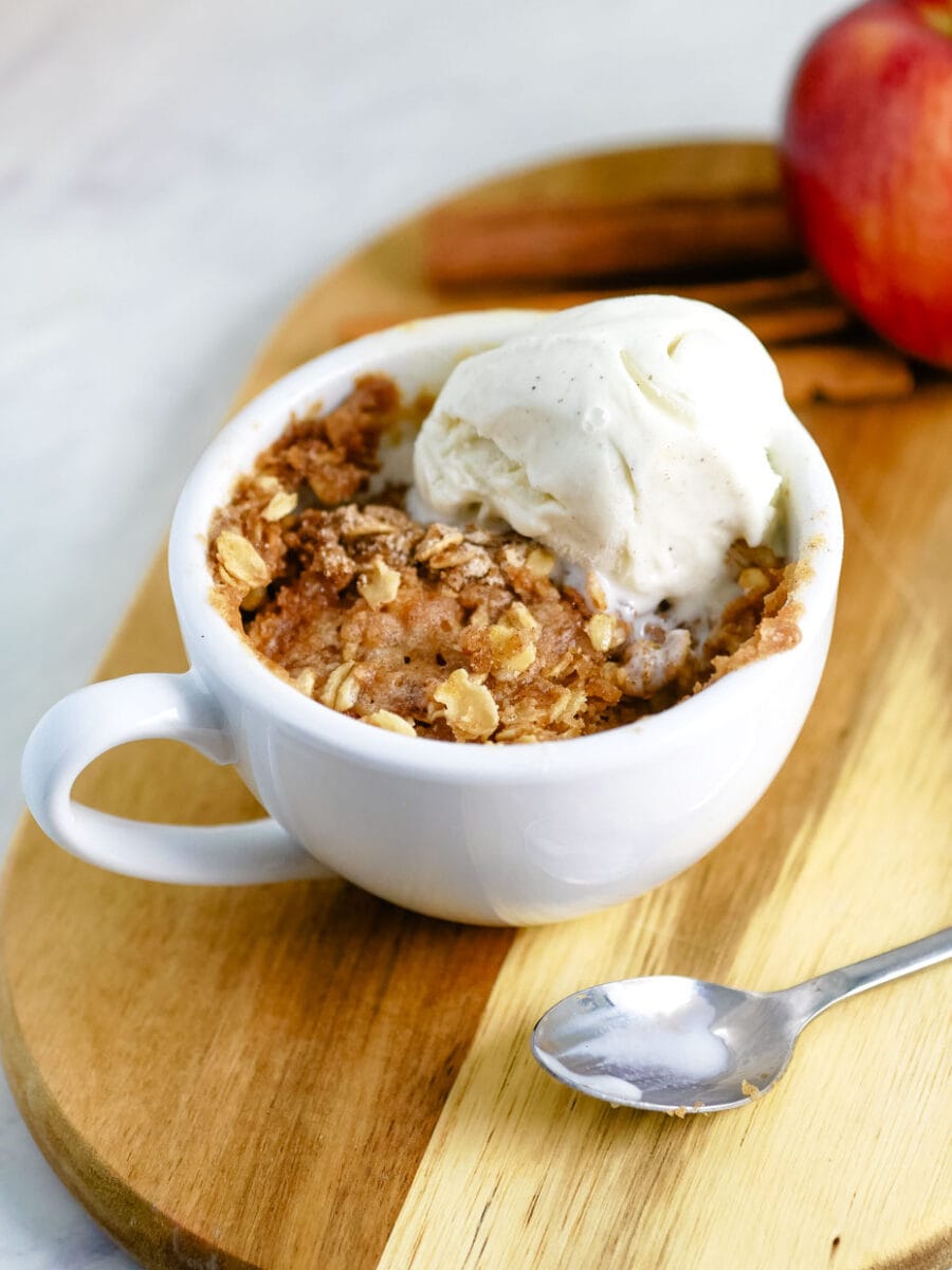 Apple crisp in a bowl with ice cream.
