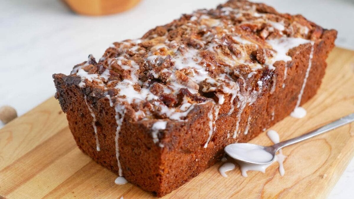 Loaf of apple fritter bread with glaze.