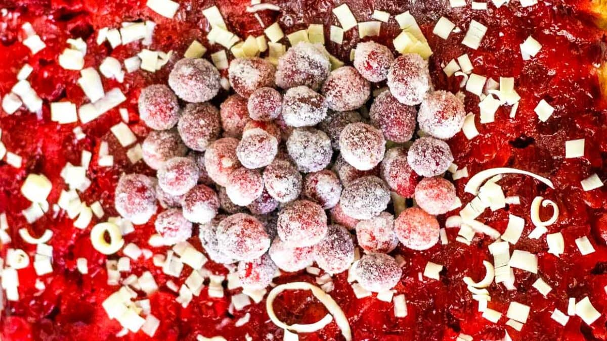 Sugared cranberries on top of a cake.
