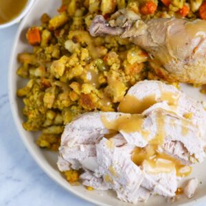 Thanksgiving turkey with gravy and stuffing on a plate.