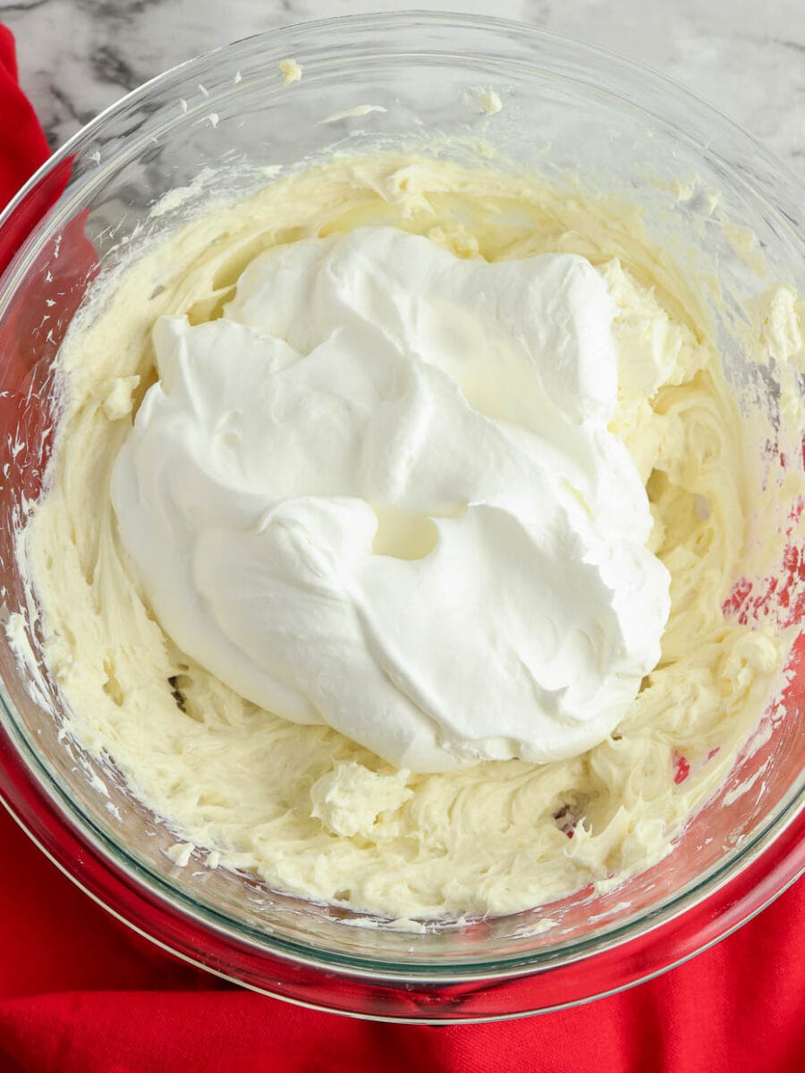 Mixing the whipped topping into the cheesecake batter.