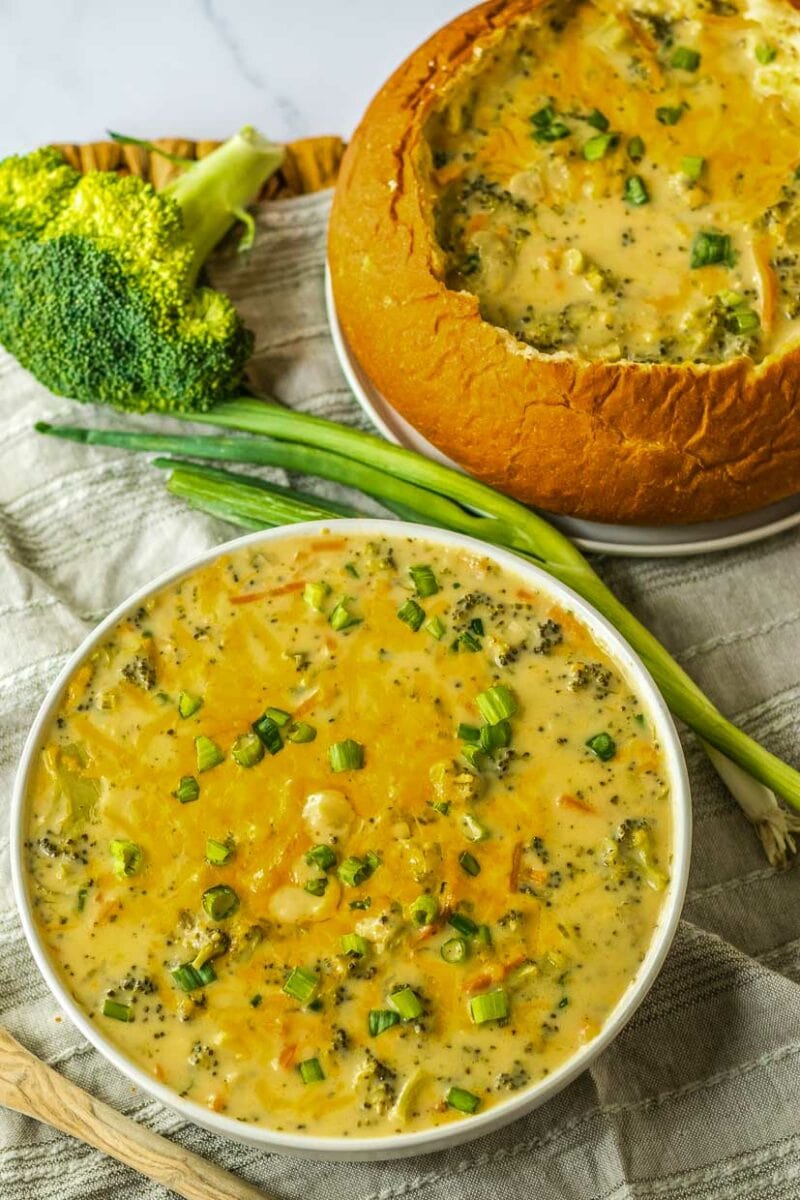 Two bowls of broccoli soup on a table.