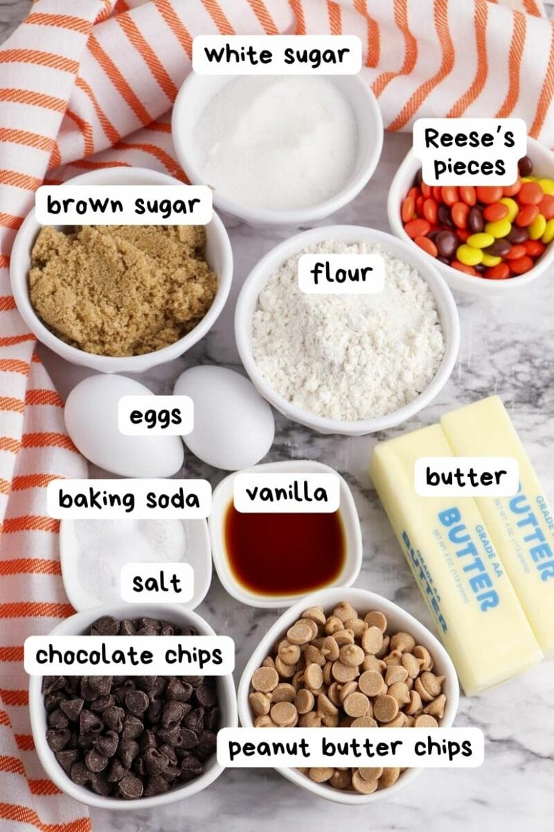 The ingredients for a chocolate chip cookie with Reese's Pieces bars.