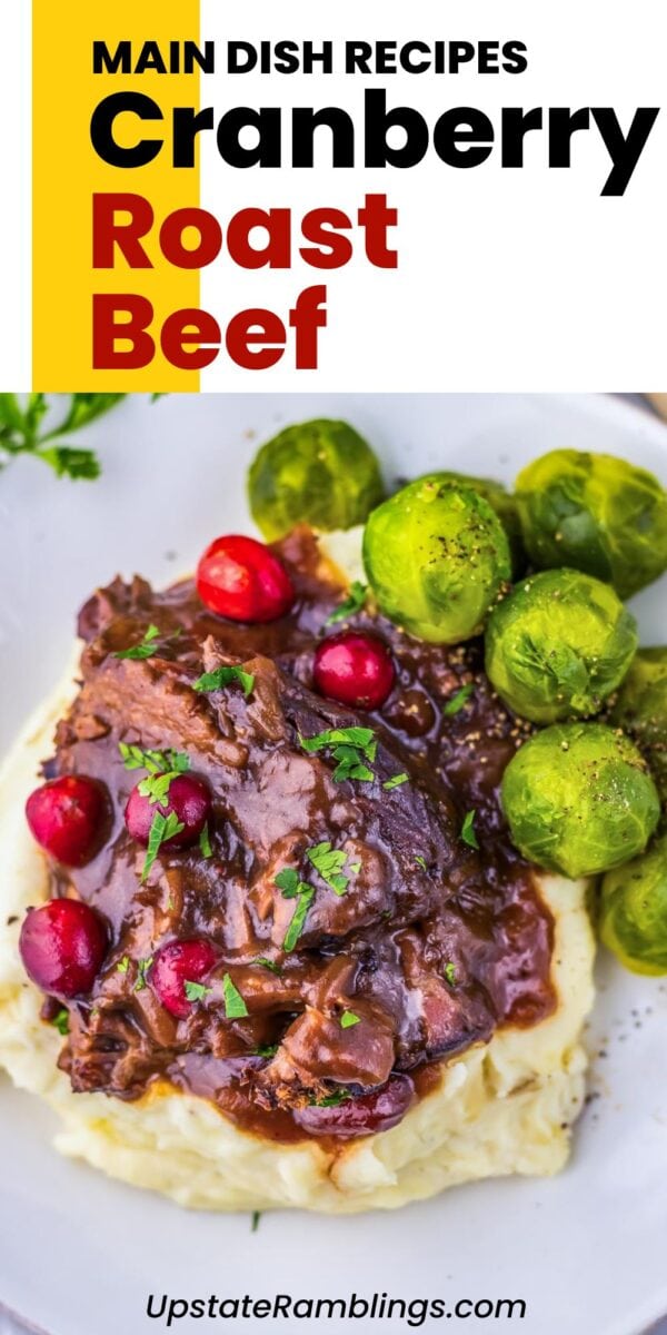 Plate of cranberry pot roast beef served over mashed potatoes with Brussels sprouts, garnished with parsley and cranberries. Text on image reads "Main Dish Recipes Cranberry Roast Beef.