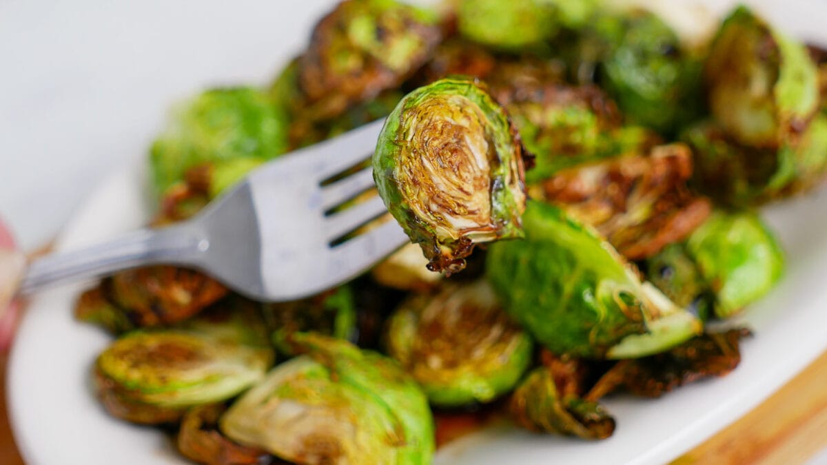 Brussels sprouts on a plate with a fork.