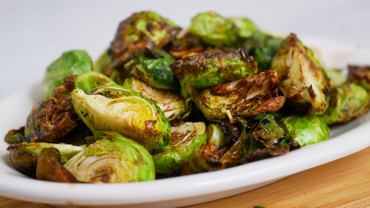 Roasted brussels sprouts in a white bowl.