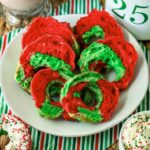 Christmas bagels on a plate with green and red sprinkles.