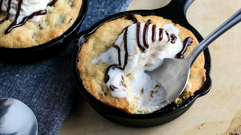 digging in to a skillet cookie with ice cream
