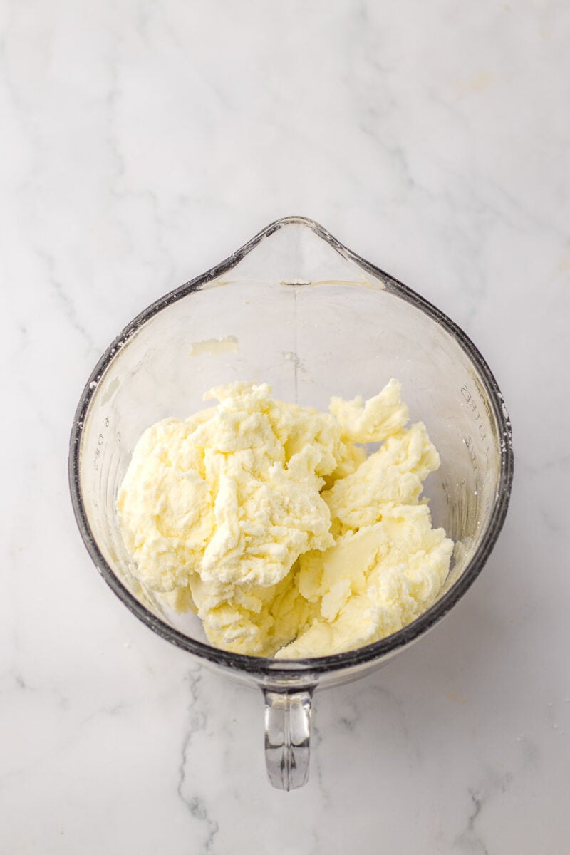 Butter in a glass mixing bowl.