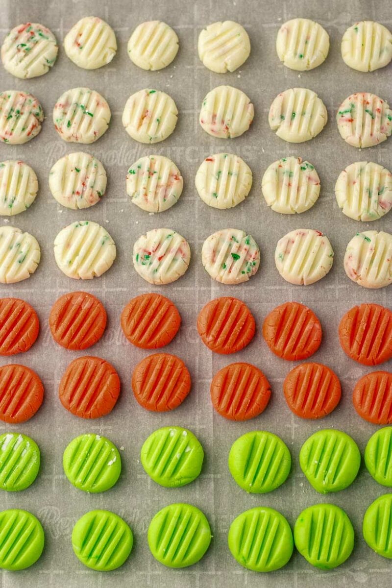 A tray of cookies with green, orange, and red sprinkles.