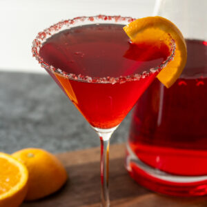 A martini with a slice of orange.