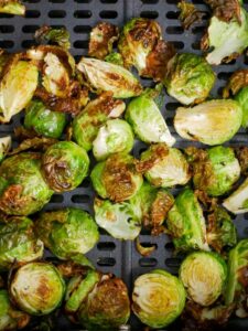 Roasted brussels sprouts on a grill.