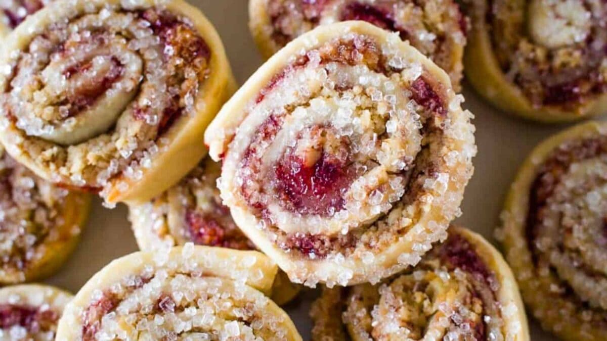 A plate with a bunch of strawberry rolls on it.