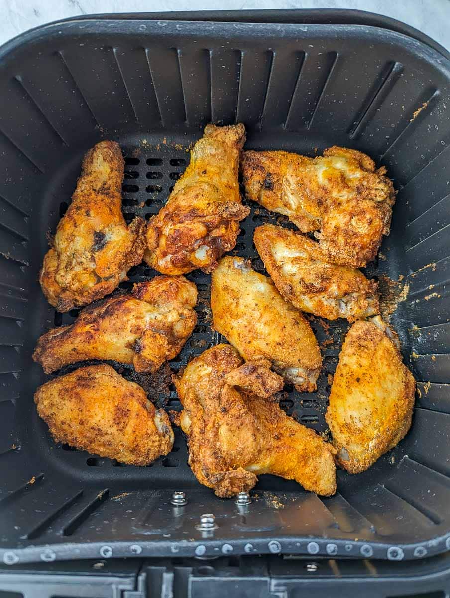 Fried chicken wings in an air fryer.