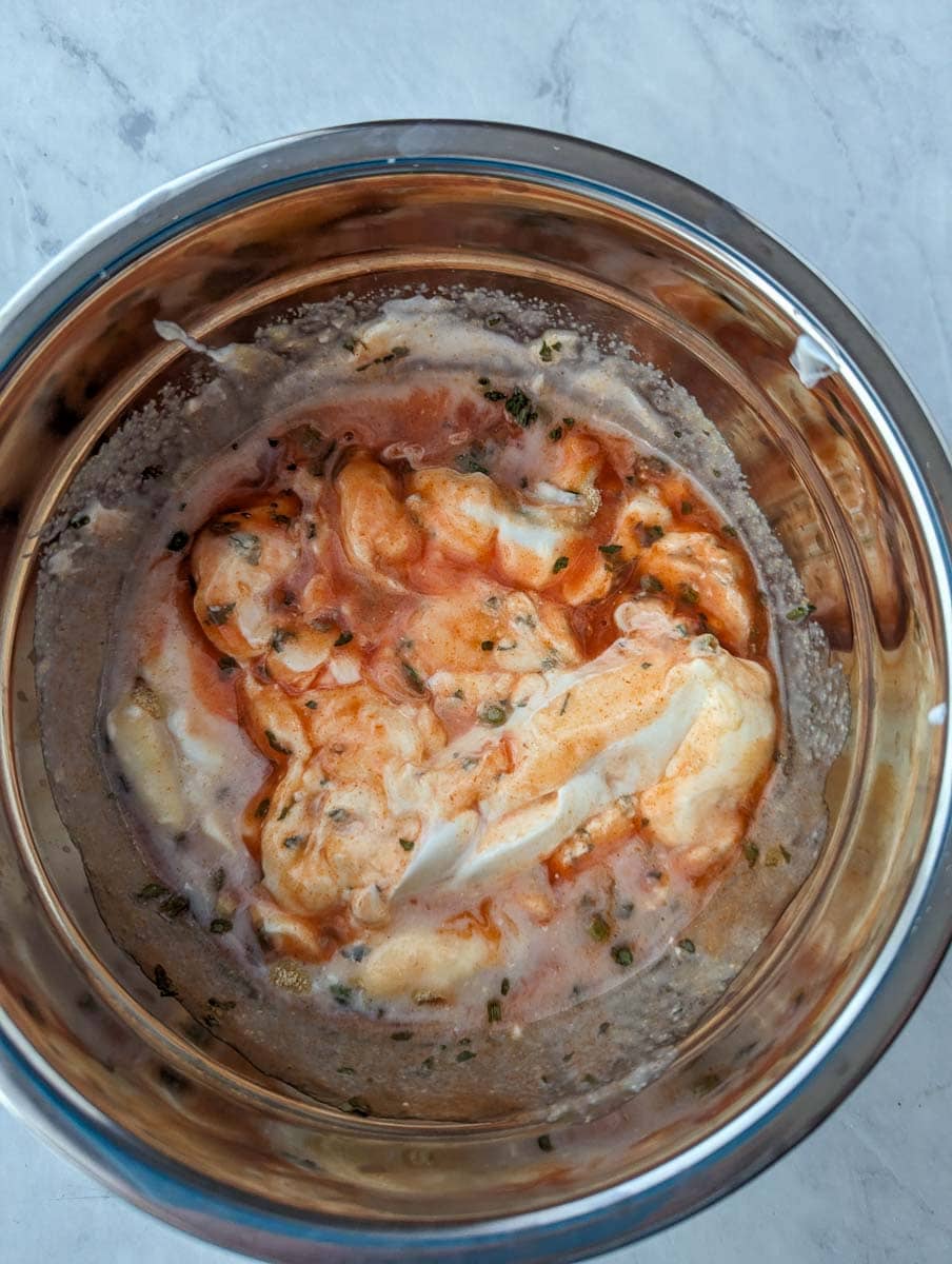 A food processor filled with shrimp and cheese.