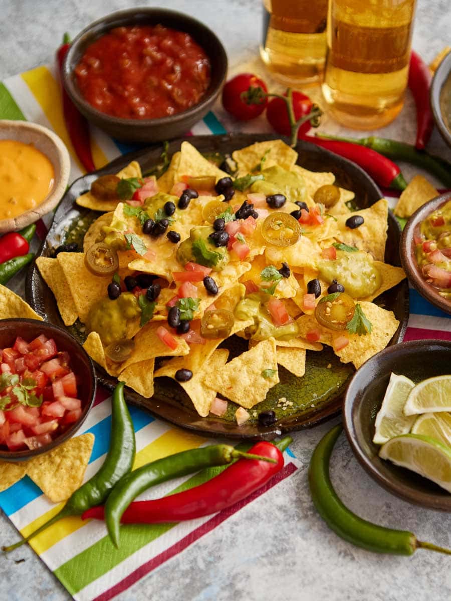 Mexican nachos and drinks on a table.