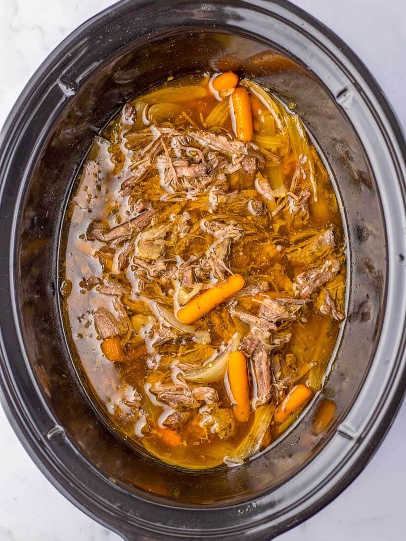 Slow cooker beef stew with carrots and onions.