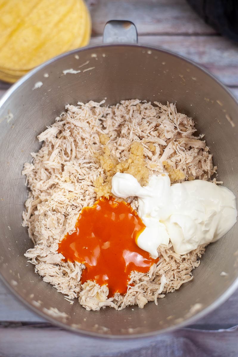 A bowl with rice, sauce and ketchup.