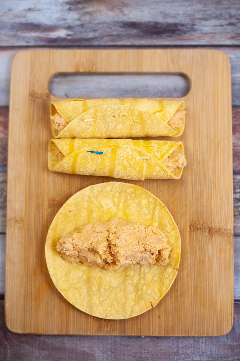 Fish tacos on a wooden cutting board.