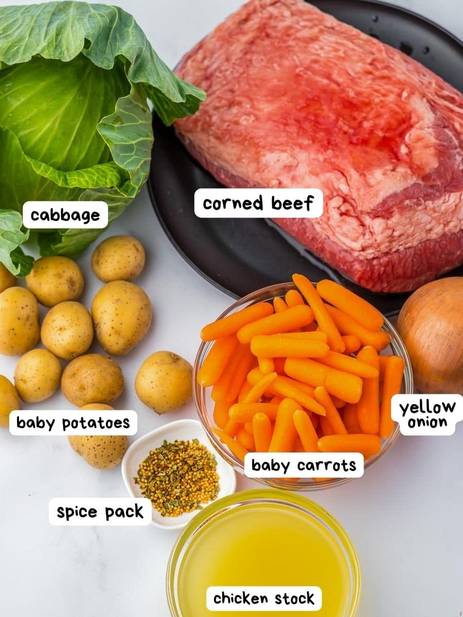 Ingredients for a crockpot corned beef with carrots, potatoes and cabbage.