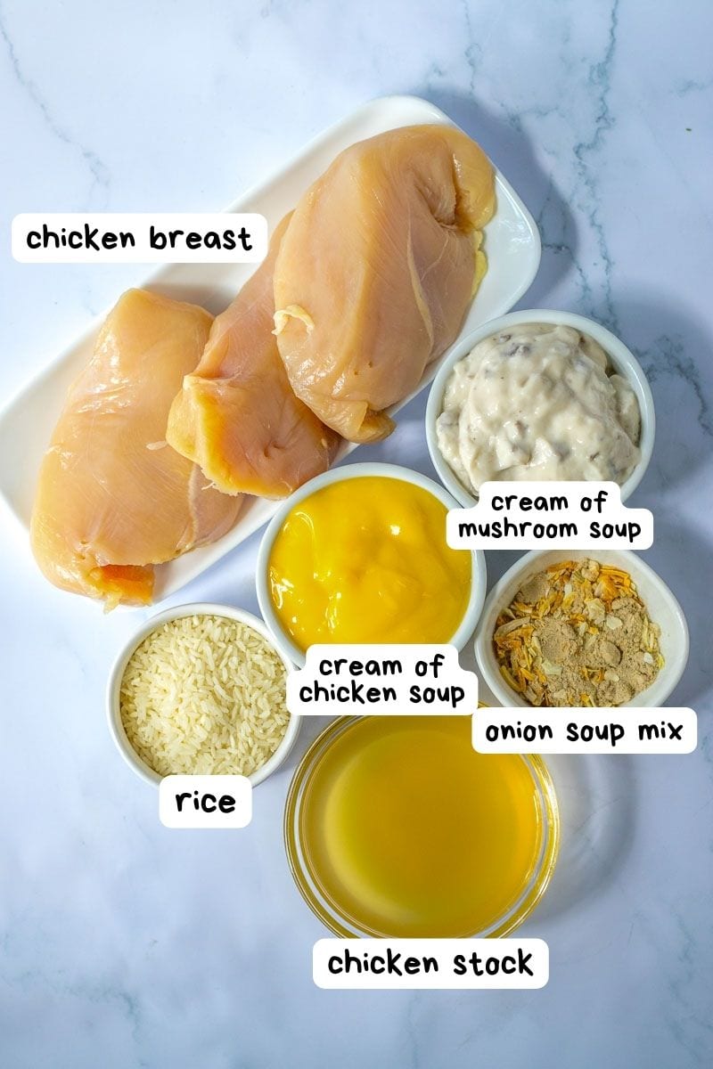 Chicken breast and other ingredients on a white plate.