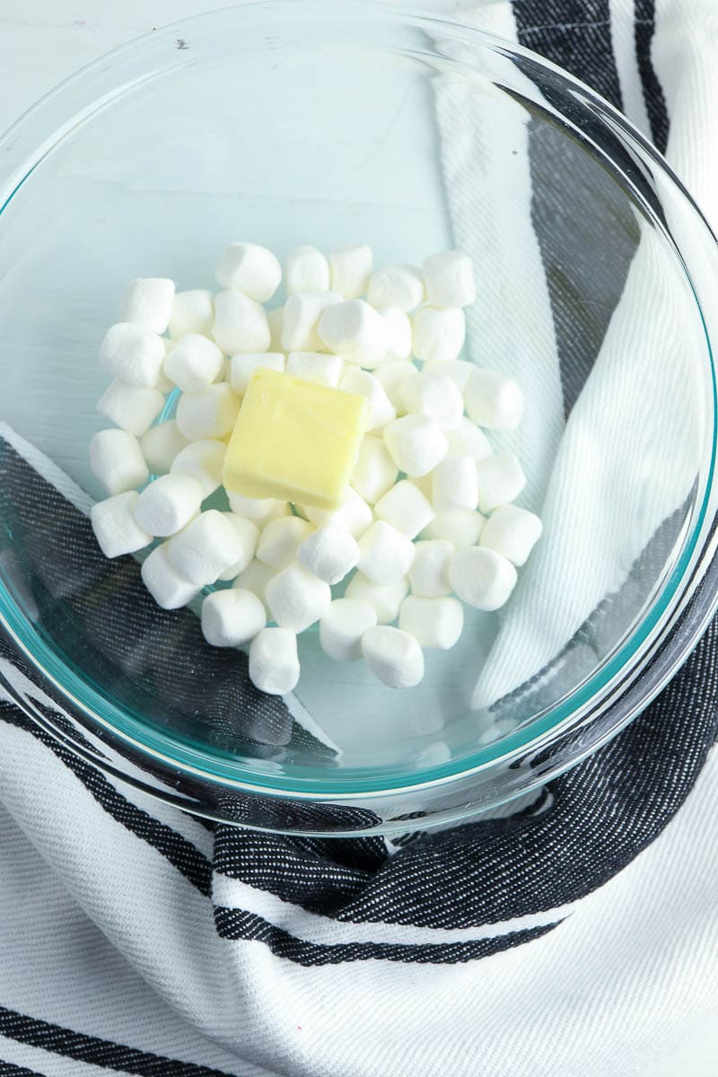 Marshmallows and butter in a glass bowl.
