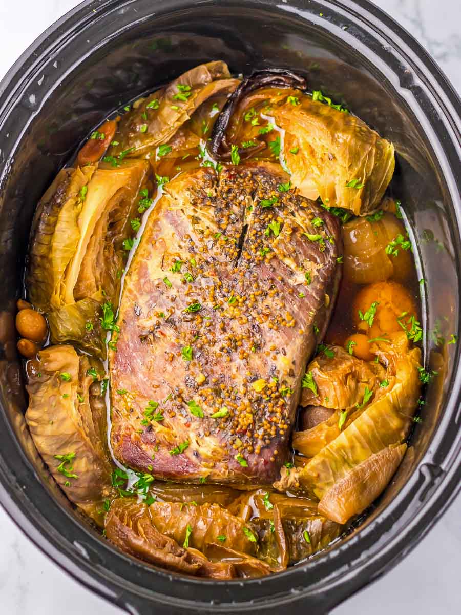 A slow cooker filled with meat and vegetables.