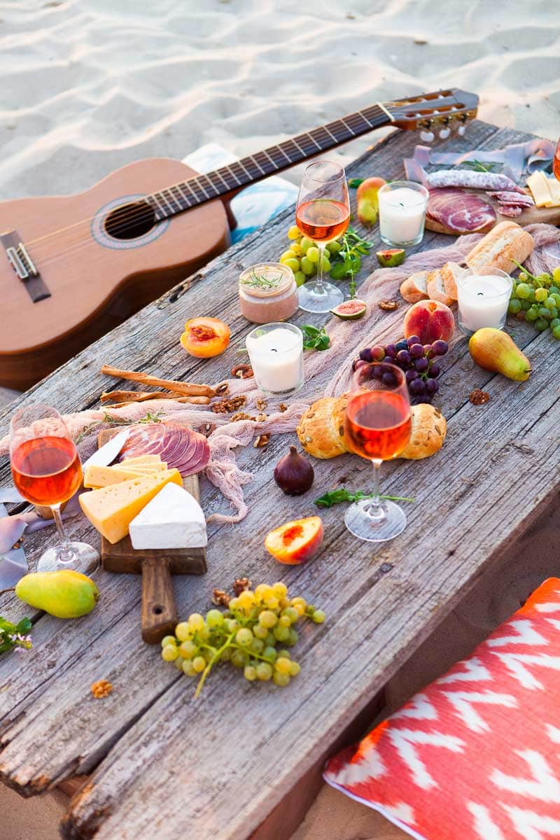 Aesthetic Picnic: A wooden table with food and a guitar on it.