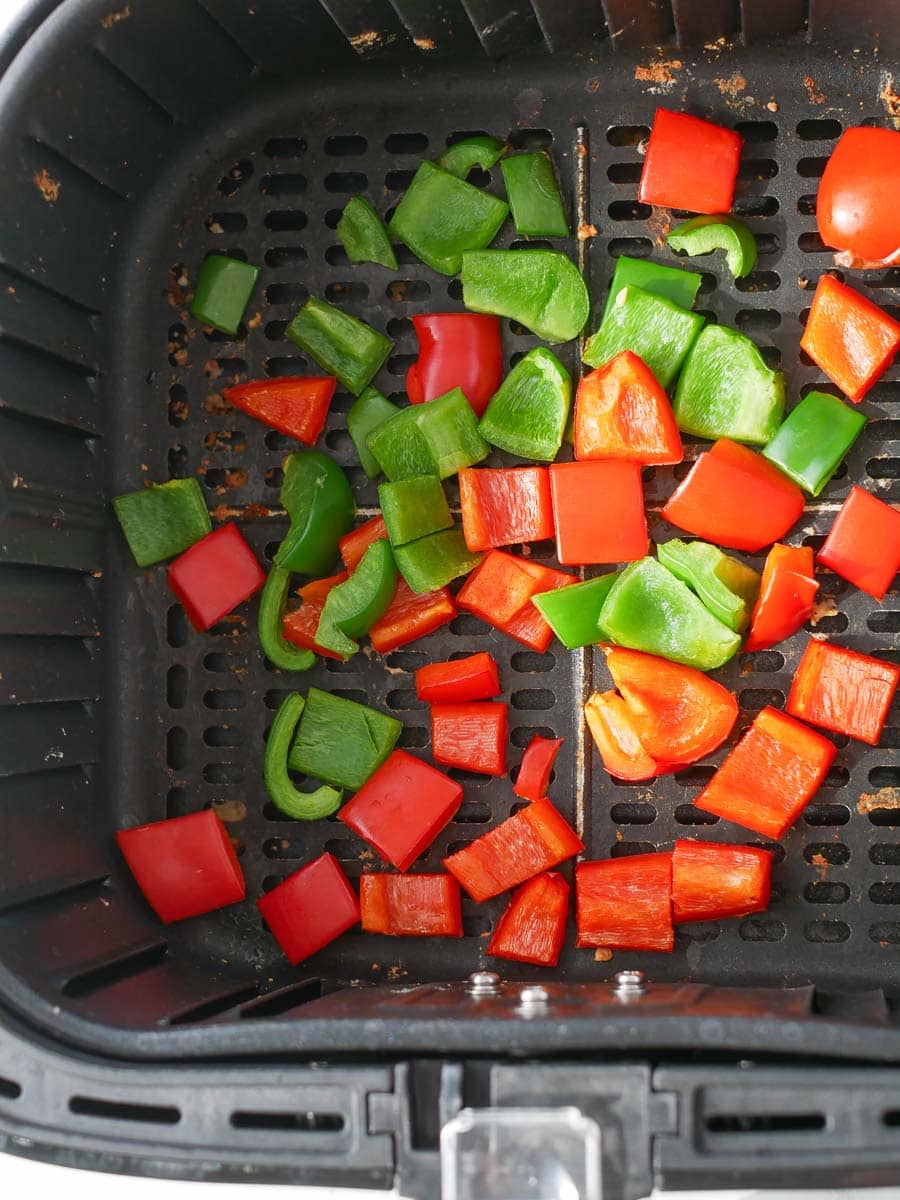 Sliced peppers in an air fryer.